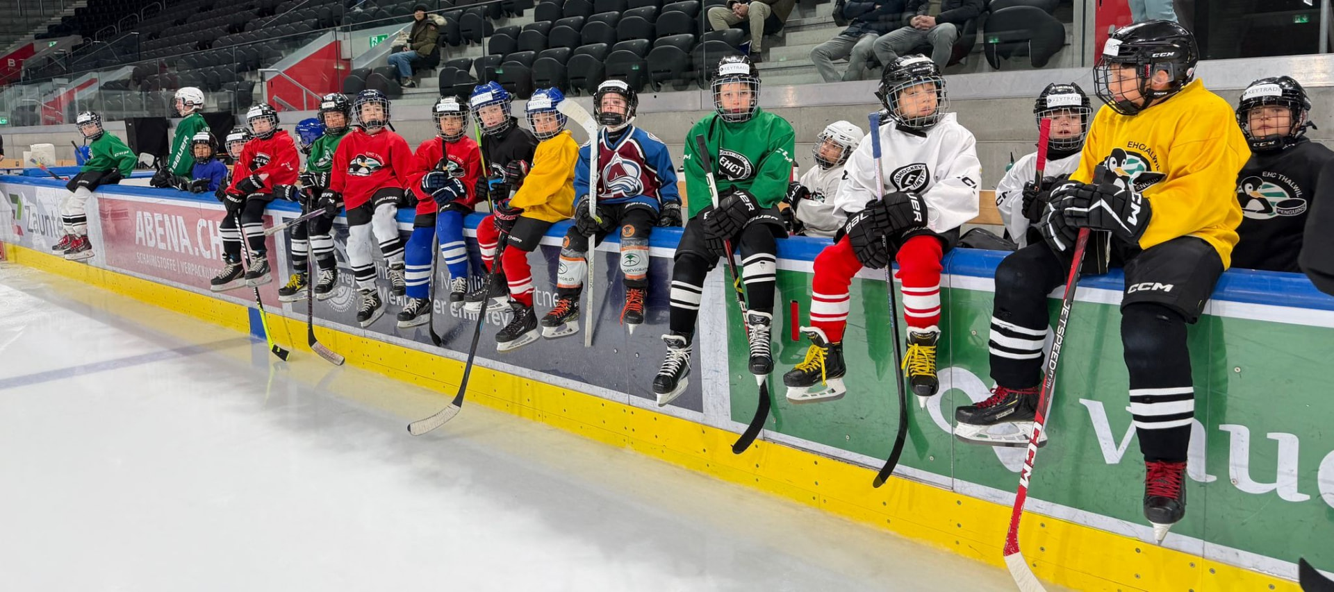 Kinder aus verschiedenen Clubs auf der Bande